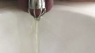 Pissing in my chastity cage