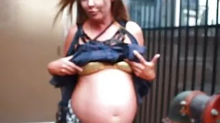 pregnant street-Showing off the belly in a bikini top