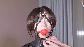 Latex girl on single gloves and gagging