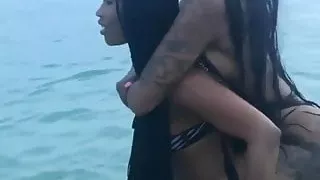 What an ass - sexy black doing selfies at the sea side.
