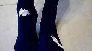 Smear cream on nylon pantyhose foot-to-foot rub