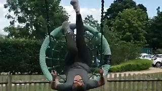 Frankie Bridge sitting in a swing