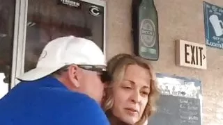 mature woman shows her tits to the public with her friends