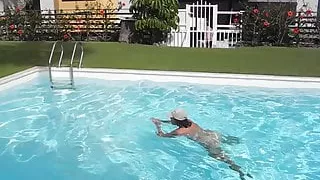 Adult woman bathing in the pool naked