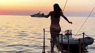 Alessandra Ambrosio jumping into the water at sunset