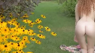 Young redhead sensually teasing in nature