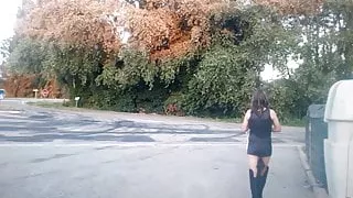 In black dress and boot with tail plug