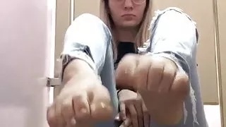 geeky blonde shows her feet in jeans