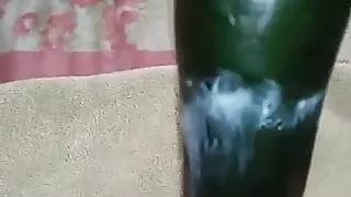 Girl fucking herself with a cucumber
