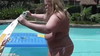 Big saggy tits blonde almost gets herself into a tiny bikini