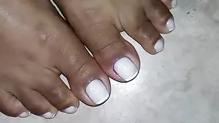 Closeup on Morenafeet's fingers with French nail polish