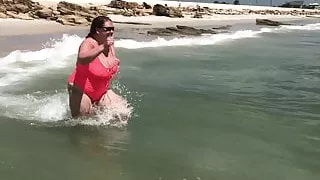 Bouncing tits running in the waves in sheer suit