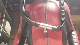 Latex catsuit and heavy rubber helmet