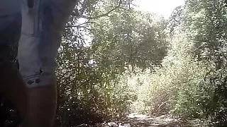 Lady peeing in the woods