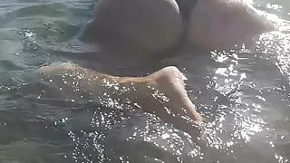 Women in sea with very big naked ass and touching pussy