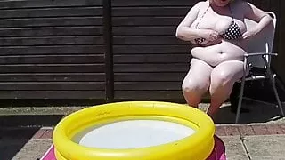 Mature with massive tits in the smallest bikini by the pool
