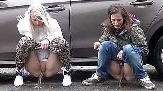Blonde And Brunette Squat And Piss Together