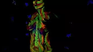 Glowing paint at night on a naked body.