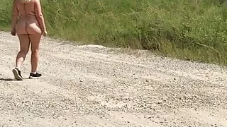 Wife outside naked – machinery in background.