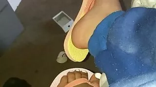 Ebony feet in colorful flip flops