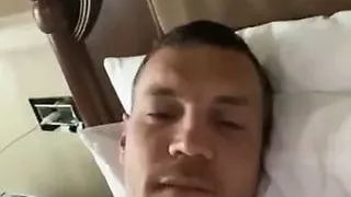 Russian footballer Artem Dzyuba playing on hotel bed