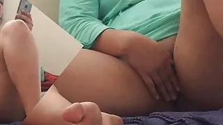 Young shaved pussy is stroked while watching porn