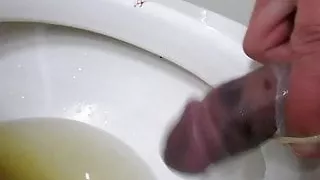 CBT broken cock pissing and wanking in condoms