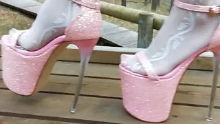 Lady L walking in towering pink extreme high heels.