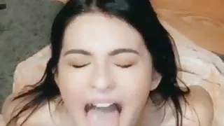 Hot brunette on her knees takes facial