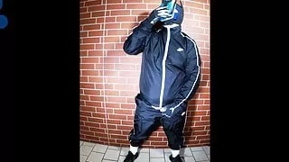 Scally Pup in shiny tracksuit pawing off and sniffing