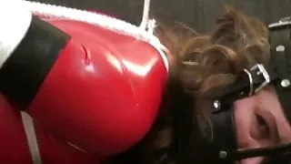 Red Latex Catsuit Girl Muzzled and Tied Up