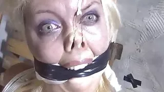 Humiliating bondage pose for a haughty blonde