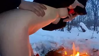 A guy and a girl fuck in the winter by the fire
