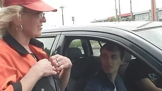 Blonde old woman pleases two strangers in the fields