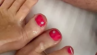 Treating her tiny toes with a creamy load