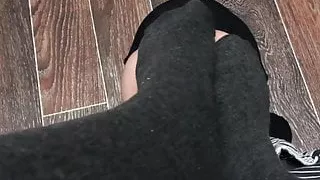 Femdome slave kisses the feet of mistress in pantyhose