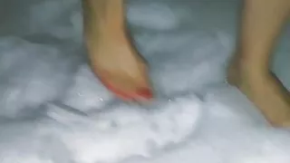 Barefoot wife walking on snow