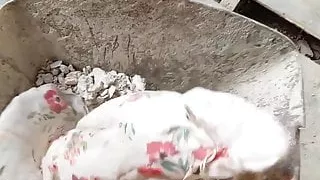 dumping floral dress in a construction trolley