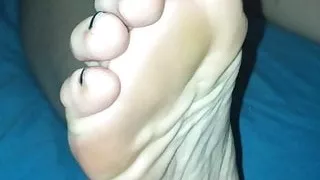Wife's feet in bed