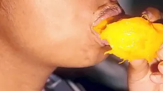 Sexy mouth ebony playing with a mango