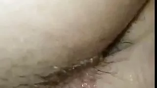 Dilation of the two openings of a hairy whore in close-up