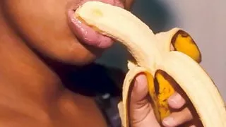 Naughty ebony with sexy lips playing with a banana