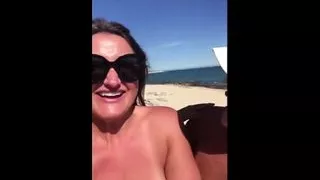 Three topless mature women showing off on the beach