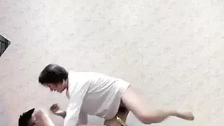 Guy and young woman having sex on sofa in living room