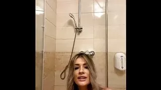 pretty blonde soaping her body in the bath