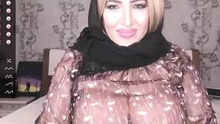 An adult oriental woman caresses her body and shows her charms