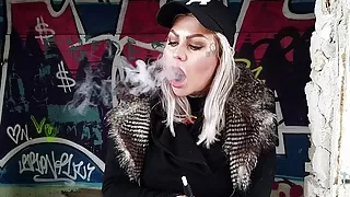 Blonde Lady Smokes An Electric Cigarette On Stairs