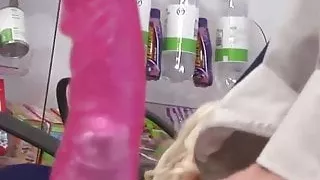 Blondes in sex shop ride cock in a threeway