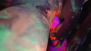 Black-light babes Nadia and Ophelia suck off a colorful cock