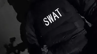 SWAT Soldier plays with his guns